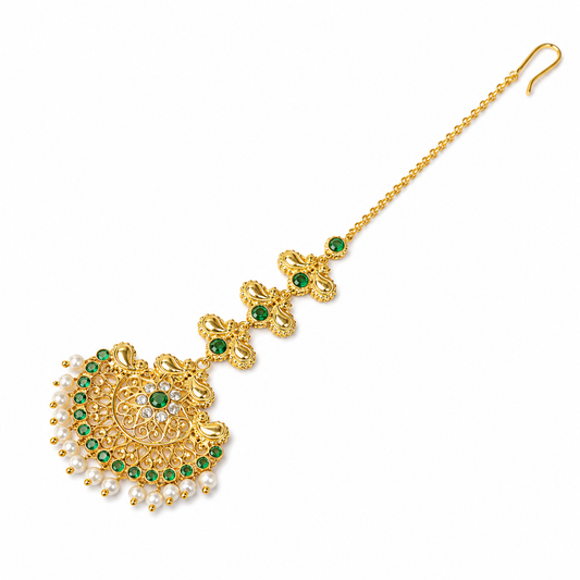 Gold-toned traditional Indian maang tikka with green stone accents, white pearl beads, and a delicate chain ending in a hook, shown on a plain white background.

