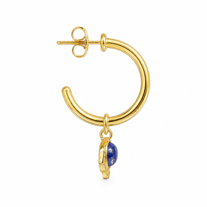 A gold hoop earring with a small dangling blue lapis lazuli stone, shown on a plain white background.


